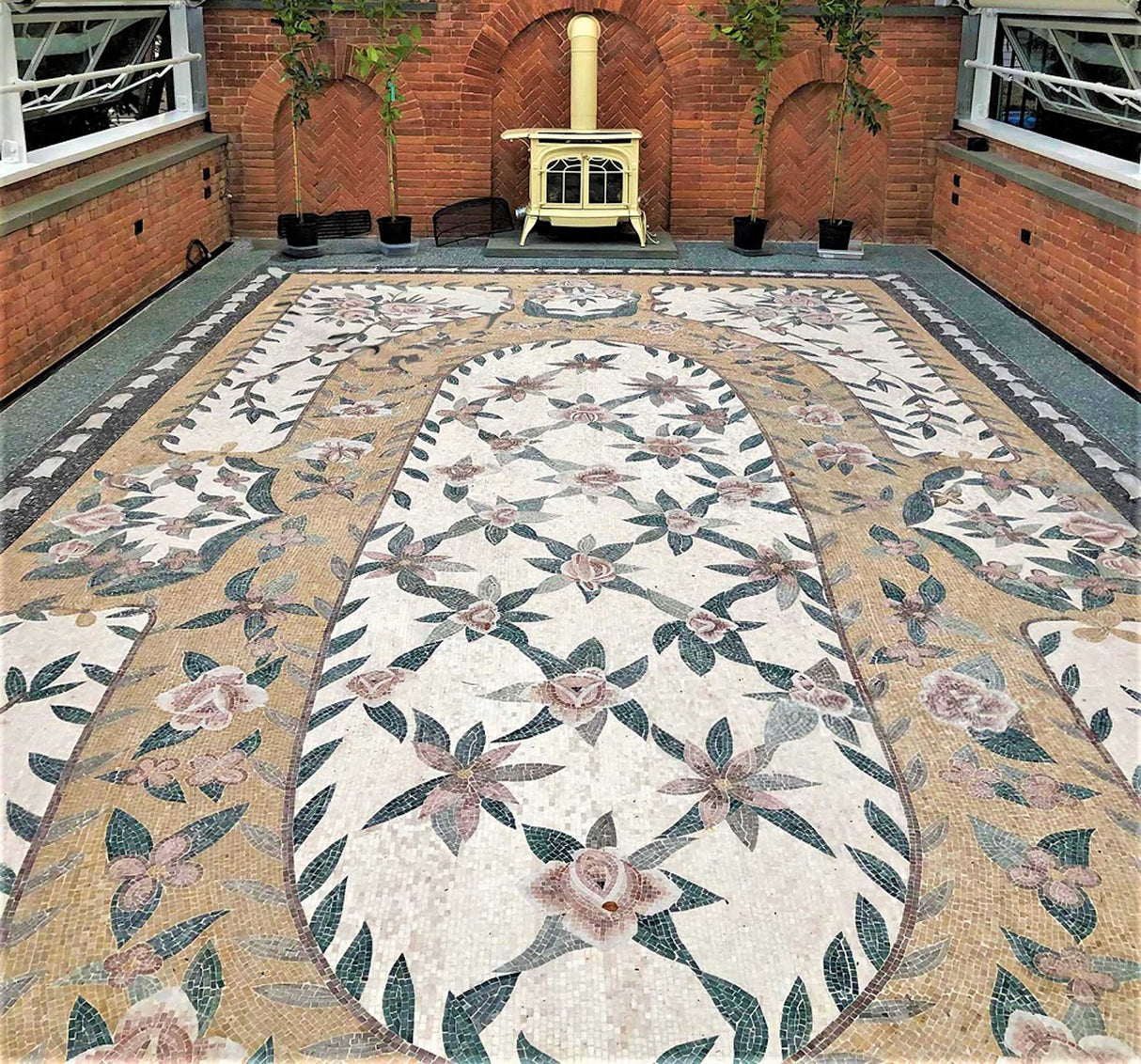 Luxury residential grand salon interior with a vintage stove and a custom handcrafted Mediterranean botanical rose lattice marble mosaic floor rug design.