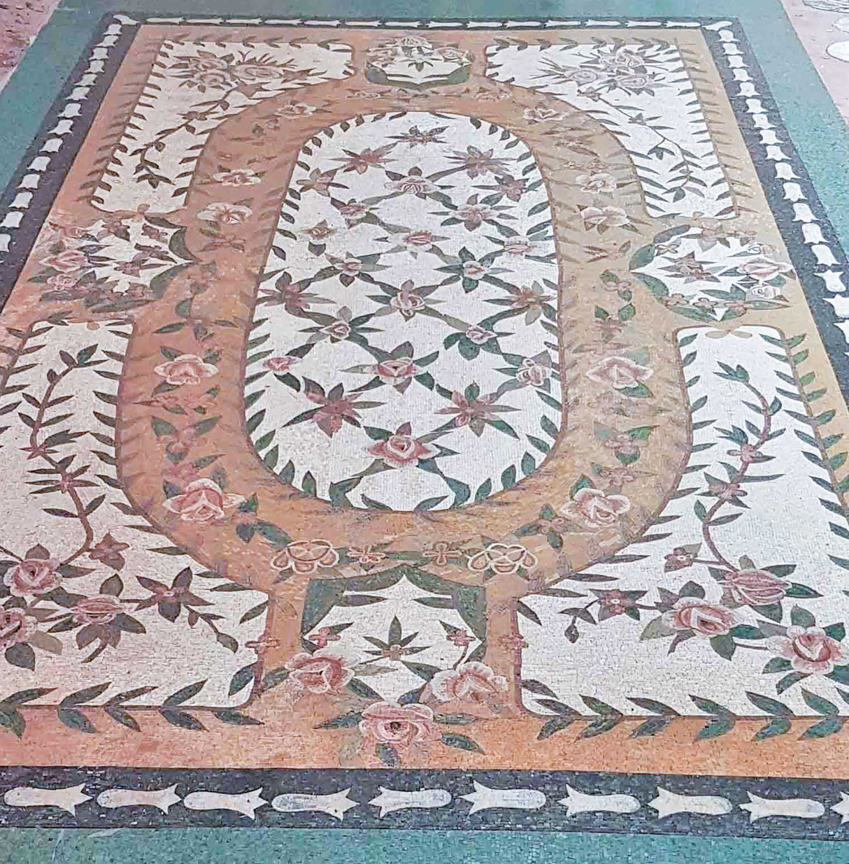 Bespoke Luxury residential grand salon interior with a vintage stove and a custom handcrafted Mediterranean botanical rose lattice marble mosaic floor rug design.