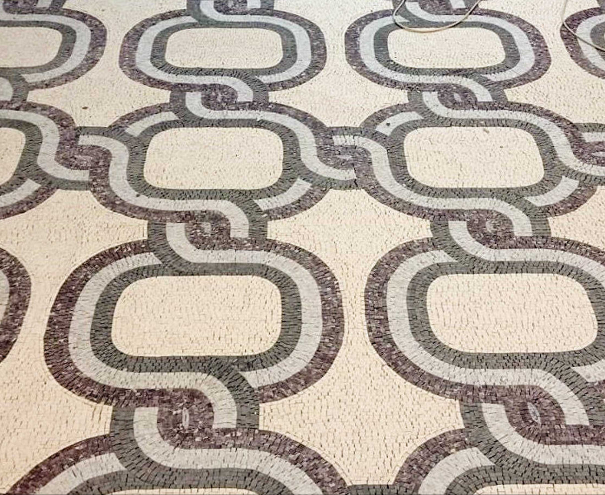 Grand luxury entry floor custom laid with Mediterranean infinity rope chain marble mosaic pattern in white, gray, and terracotta red colors.