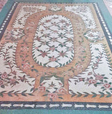 Bespoke Luxury residential grand salon interior with a vintage stove and a custom handcrafted Mediterranean botanical rose lattice marble mosaic floor rug design.