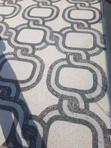 Close-up of a patterned mosaic floor with interlocking shapes