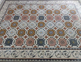 Macro photograph highlighting the artisanal hand-cut stone tesserae and seamless interlocking seams of the mosaic rug.