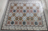 Grand scale Mediterranean octagon and vine marble mosaic floor rug laid out in a workshop room showing the full pattern.