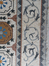 Elite residential grand salon installation featuring a custom-scaled Roman style mosaic stone rug.