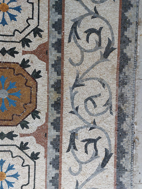 Elite residential grand salon installation featuring a custom-scaled Roman style mosaic stone rug.